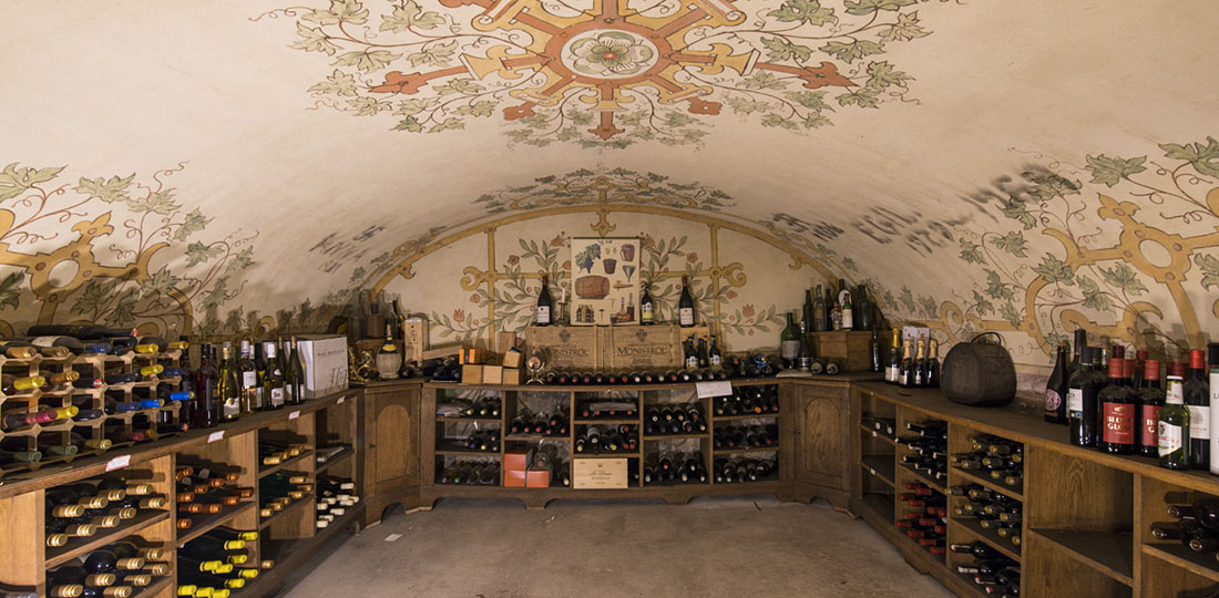 Slottets vinkällare i ett 1300-tals valv. Takmålningar och inredning i ek.