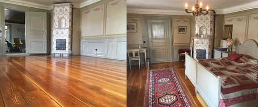 Rum med nyslipat golv och rödvit kakelugn från Uppsala Ekeby
